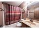 Traditional bathroom featuring a shower-tub combo and wood cabinets at 562 Monte Vista Dr, Greenwood, IN 46143