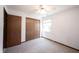 Cozy bedroom featuring a ceiling fan, large window, and double door closet at 562 Monte Vista Dr, Greenwood, IN 46143