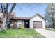 Charming home with a brick facade, mature trees, a well-manicured lawn, and an attached garage at 562 Monte Vista Dr, Greenwood, IN 46143