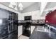 Well-lit kitchen featuring black appliances, white cabinets and a stylish backsplash at 562 Monte Vista Dr, Greenwood, IN 46143