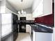 An efficient kitchen with white cabinets, dark countertop, and modern appliances at 562 Monte Vista Dr, Greenwood, IN 46143