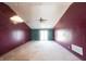 Spacious living room with a ceiling fan, natural light, and access to the backyard at 562 Monte Vista Dr, Greenwood, IN 46143