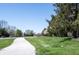 A view of a neighborhood pathway lined with lush greenery and trees, providing a serene and inviting outdoor space at 562 Monte Vista Dr, Greenwood, IN 46143