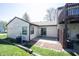 An outdoor patio area features sliding glass doors, a stone border and adjacent greenery, with an air conditioning unit nearby at 562 Monte Vista Dr, Greenwood, IN 46143