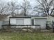 A wooden deck and small yard for outdoor enjoyment are attached to this cute garage, offering extra space at 5810 Greenfield Ave, Indianapolis, IN 46219