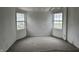 A bedroom featuring two windows and neutral carpet offers lots of potential to create your dream space at 5810 Greenfield Ave, Indianapolis, IN 46219