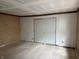 Bedroom featuring paneled walls, hardwood floors, and closet, offering a comfortable and customizable space at 5810 Greenfield Ave, Indianapolis, IN 46219