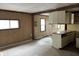 Kitchen featuring retro cabinets, countertop, paneled walls and space for customization at 5810 Greenfield Ave, Indianapolis, IN 46219