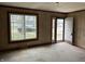 Living room with a window, front door, paneled walls and hardwood floors, offering space for relaxation at 5810 Greenfield Ave, Indianapolis, IN 46219