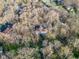 Aerial view of property showing house, driveway, and a landscape of trees on a sunny day at 5917 Camelback Ct, Indianapolis, IN 46250