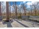 Back deck with built-in seating, offering a peaceful retreat with views of the wooded surroundings at 5917 Camelback Ct, Indianapolis, IN 46250