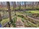 Backyard staircase surrounded by lush greenery and natural light, leading to the expansive outdoor space at 5917 Camelback Ct, Indianapolis, IN 46250