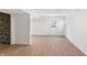 Basement featuring light wood flooring, stone wall accent, and bright white walls with a door leading outside at 5917 Camelback Ct, Indianapolis, IN 46250