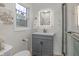 Bathroom with illuminated mirror, grey vanity with storage, and tiled shower with glass door at 5917 Camelback Ct, Indianapolis, IN 46250