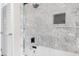 Modern bathroom featuring stylish marble tile, black hardware, and a convenient built-in shower niche at 5917 Camelback Ct, Indianapolis, IN 46250