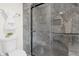 Modern bathroom with a glass shower featuring marbled walls and black hardware at 5917 Camelback Ct, Indianapolis, IN 46250