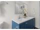 Bathroom with a white double vanity sink, blue cabinets, square mirrors, and white walls at 5917 Camelback Ct, Indianapolis, IN 46250