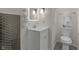 Modern bathroom featuring an updated vanity, a toilet, and a shower with decorative tile at 5917 Camelback Ct, Indianapolis, IN 46250