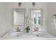 Bright bathroom featuring double sinks, modern fixtures, and minimalist design at 5917 Camelback Ct, Indianapolis, IN 46250