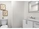 Bathroom with a white vanity, toilet, and decorative wall art at 5917 Camelback Ct, Indianapolis, IN 46250