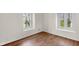 Bright bedroom featuring two windows and hardwood floors at 5917 Camelback Ct, Indianapolis, IN 46250