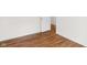 A well-lit bedroom with hardwood floors and a partially opened door at 5917 Camelback Ct, Indianapolis, IN 46250