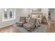 Cozy bedroom featuring hardwood floors, accent chairs, and a neutral color palette at 5917 Camelback Ct, Indianapolis, IN 46250