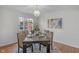 Bright dining room with a modern chandelier, a large window, and stylish decor at 5917 Camelback Ct, Indianapolis, IN 46250