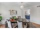 Well-lit dining room with a chandelier, a large window, and an open view to the kitchen at 5917 Camelback Ct, Indianapolis, IN 46250