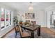 Inviting dining room features a modern chandelier and a large window for natural light at 5917 Camelback Ct, Indianapolis, IN 46250