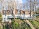 View of a home's rear facade with a long deck and stone steps leading up the yard at 5917 Camelback Ct, Indianapolis, IN 46250