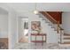 Elegant foyer with marble flooring, a decorative table, and a staircase with wooden accents at 5917 Camelback Ct, Indianapolis, IN 46250