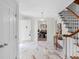 Bright foyer boasts marble floors, a staircase, and flows into the dining room at 5917 Camelback Ct, Indianapolis, IN 46250