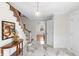 Bright foyer with a marble floor, a wooden staircase, and a decorative half-round table at 5917 Camelback Ct, Indianapolis, IN 46250