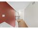 Upstairs hallway with hardwood floors, and red accent wall at 5917 Camelback Ct, Indianapolis, IN 46250