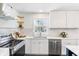 Renovated kitchen with stainless steel appliances, new countertops, and modern design at 5917 Camelback Ct, Indianapolis, IN 46250