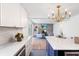 Open concept kitchen with new cabinets, marble counters, stainless appliances and view to the living room at 5917 Camelback Ct, Indianapolis, IN 46250