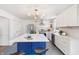 Modern kitchen with white cabinets, stainless steel appliances, a spacious island, and a beautiful chandelier at 5917 Camelback Ct, Indianapolis, IN 46250