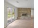 Spacious living room featuring a stone fireplace and a sliding glass door to the backyard at 5917 Camelback Ct, Indianapolis, IN 46250