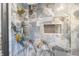 Luxury shower featuring dark-veined tile, gold fixtures, and a convenient recessed niche at 5917 Camelback Ct, Indianapolis, IN 46250