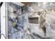 Modern shower with gray marble tiles, gold shower fixtures, and a built-in niche at 5917 Camelback Ct, Indianapolis, IN 46250