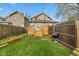 Backyard with wooden fence, grill, green grass, and a new deck, perfect for outdoor living at 601 Wallace Ave, Indianapolis, IN 46201