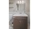 Well-lit bathroom showcasing a dark vanity and toilet, enhanced by open shelving at 601 Wallace Ave, Indianapolis, IN 46201