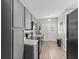 Well-lit kitchen boasts gray cabinetry, modern appliances, and stylish countertops with wood floors at 601 Wallace Ave, Indianapolis, IN 46201