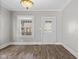 Well-lit living room with hardwood floors, window and an elegant stained glass light fixture at 601 Wallace Ave, Indianapolis, IN 46201