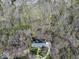 Overhead view of a home in a heavily wooded area, with a manicured lawn and circular driveway at 6013 Yellow Birch Ct, Avon, IN 46123