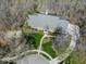Aerial shot of a beautiful home nestled in a wooded area, featuring a lush lawn and winding driveway at 6013 Yellow Birch Ct, Avon, IN 46123