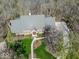 Overhead shot of a brick home with green lawn and a driveway leading to the street, surrounded by trees at 6013 Yellow Birch Ct, Avon, IN 46123
