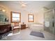 Bathroom featuring a marble-trimmed jacuzzi tub, tiled floor, glass shower, and double windows at 6013 Yellow Birch Ct, Avon, IN 46123