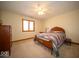 Cozy bedroom with a ceiling fan, carpet, and a brightly colored patchwork quilt at 6013 Yellow Birch Ct, Avon, IN 46123